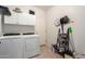 A laundry room featuring side-by-side washer and dryer, with storage shelves and cabinets at 241 W Roadrunner Dr, Chandler, AZ 85286