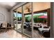 Spacious covered patio featuring comfortable outdoor seating, ceiling fan, and view of the pool at 241 W Roadrunner Dr, Chandler, AZ 85286