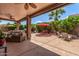 Spacious covered patio, ceiling fans, stone pillars, providing a comfortable outdoor living area at 241 W Roadrunner Dr, Chandler, AZ 85286