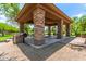 Community picnic area featuring a shaded pavilion with tables and a barbecue grill at 241 W Roadrunner Dr, Chandler, AZ 85286