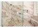 Spa-like shower featuring sleek glass doors, pebble flooring, and stone-look tile at 241 W Roadrunner Dr, Chandler, AZ 85286