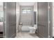 Bright bathroom with a shower-tub combo and tiled walls between two doors at 2516 W Joy Ranch Rd, Phoenix, AZ 85086