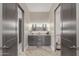 Bathroom with double sinks, an illuminated mirror, and wood-look tiled floors at 2516 W Joy Ranch Rd, Phoenix, AZ 85086