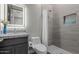 Bright bathroom featuring a gray single sink vanity with granite countertop and modern tiled shower at 2516 W Joy Ranch Rd, Phoenix, AZ 85086