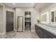 Bathroom featuring dual sinks, granite countertop, dark wood cabinetry, and a walk-in closet at 2516 W Joy Ranch Rd, Phoenix, AZ 85086