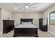 Spacious bedroom featuring neutral walls, wood-look tile flooring, and a secure black safe at 2516 W Joy Ranch Rd, Phoenix, AZ 85086