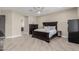 Spacious bedroom featuring neutral walls, wood-look tile flooring, and a dark wood furniture set at 2516 W Joy Ranch Rd, Phoenix, AZ 85086