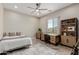 Cozy bedroom featuring a ceiling fan, wooden desk and decorative shelving at 2516 W Joy Ranch Rd, Phoenix, AZ 85086