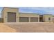 Exterior of home with three car garage and desert rock landscape at 2516 W Joy Ranch Rd, Phoenix, AZ 85086