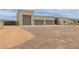 Exterior of home featuring three car garage, rock landscaping and desert foliage at 2516 W Joy Ranch Rd, Phoenix, AZ 85086