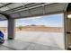 Open garage door with view of mountains, surrounding desert landscape and concrete driveway at 2516 W Joy Ranch Rd, Phoenix, AZ 85086