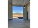 Clean, spacious garage showcasing an automatic door with a view of the clear blue sky and distant mountains at 2516 W Joy Ranch Rd, Phoenix, AZ 85086