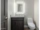 Modern half bathroom with gray vanity, stylish granite counter top, and decorative framed LED mirror at 2516 W Joy Ranch Rd, Phoenix, AZ 85086