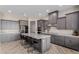 Open kitchen with gray cabinets, large island with seating, and stainless steel appliances at 2516 W Joy Ranch Rd, Phoenix, AZ 85086