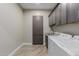 Functional laundry room with modern cabinetry, granite countertops, and a side-by-side washer and dryer at 2516 W Joy Ranch Rd, Phoenix, AZ 85086