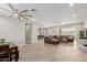 Spacious open-concept living area with tile floors, ceiling fans, and modern decor at 2516 W Joy Ranch Rd, Phoenix, AZ 85086