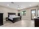 Main bedroom with tile floors, ceiling fan, and access to private patio at 2516 W Joy Ranch Rd, Phoenix, AZ 85086