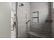Modern tiled shower featuring a built-in shower bench and a recessed shelving niche at 2516 W Joy Ranch Rd, Phoenix, AZ 85086