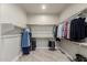 Walk-in closet featuring a lot of space with a wall to wall hanging rack and wood-look tile flooring at 2516 W Joy Ranch Rd, Phoenix, AZ 85086
