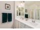 Bright bathroom with double sinks, white cabinetry, and mirrors, providing ample space at 2631 S Sulley Dr # 106, Gilbert, AZ 85295