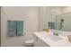 Bright bathroom with a single sink, mirror, and a tiled shower featuring recessed shelving at 2631 S Sulley Dr # 106, Gilbert, AZ 85295
