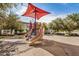Community playground area with shade structure, slides, and a soft, sandy ground at 2631 S Sulley Dr # 106, Gilbert, AZ 85295
