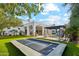 Sprawling backyard with well manicured green space, pool, pergola and covered patio perfect for entertaining at 2748 E Warbler Rd, Gilbert, AZ 85297