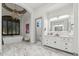 Lavish bathroom with modern vanity, soaking tub, beautiful tile, and elegant chandelier at 2748 E Warbler Rd, Gilbert, AZ 85297