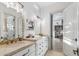 Bright bathroom with double vanity, modern lighting, and doorway view of a walk-in closet at 2748 E Warbler Rd, Gilbert, AZ 85297