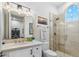 Bright bathroom with travertine tile shower and white cabinets at 2748 E Warbler Rd, Gilbert, AZ 85297