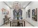 Elegant dining room with a modern table, stylish chairs, and contemporary chandelier at 2748 E Warbler Rd, Gilbert, AZ 85297