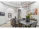 Modern dining room featuring a long table, stylish seating, and contemporary chandeliers for a sophisticated ambiance at 2748 E Warbler Rd, Gilbert, AZ 85297