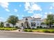 Stunning stucco home with manicured lawn and beautiful architectural details under a bright blue sky at 2748 E Warbler Rd, Gilbert, AZ 85297