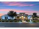 Beautiful home with warm outdoor lighting enhancing the curb appeal at dusk at 2748 E Warbler Rd, Gilbert, AZ 85297