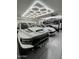 Multi-vehicle storage with a modern car lift and hexagon ceiling lights at 2748 E Warbler Rd, Gilbert, AZ 85297