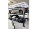 Contemporary garage with car lift and multiple vehicles at 2748 E Warbler Rd, Gilbert, AZ 85297