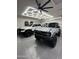 Spacious garage equipped with modern lighting, a ceiling fan, and parking at 2748 E Warbler Rd, Gilbert, AZ 85297