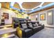 Spacious home theater with tiered seating and a large screen for an immersive experience at 2748 E Warbler Rd, Gilbert, AZ 85297