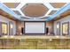 Home theater room with elevated seating and a custom bar perfect for entertaining at 2748 E Warbler Rd, Gilbert, AZ 85297