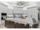 Bright kitchen with white cabinets, an island with seating, and stainless steel appliances at 2748 E Warbler Rd, Gilbert, AZ 85297