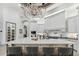 Beautiful kitchen island with white countertop, seating for four, and cabinets with modern lighting at 2748 E Warbler Rd, Gilbert, AZ 85297