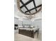 Beautiful kitchen featuring white cabinets, a central island with seating, and unique lighting fixtures at 2748 E Warbler Rd, Gilbert, AZ 85297