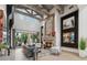 Bright, spacious living room with beamed ceilings, stone fireplace, and outdoor access at 2748 E Warbler Rd, Gilbert, AZ 85297
