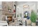 Open-concept living room features a stone fireplace, stylish decor, and bright lighting at 2748 E Warbler Rd, Gilbert, AZ 85297