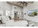 Bright, airy main bedroom featuring wood-beamed ceiling, hardwood floors, and neutral decor at 2748 E Warbler Rd, Gilbert, AZ 85297