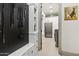 Hallway with large mudroom area, custom storage, stainless steel refrigerator and appliances and painting at 2748 E Warbler Rd, Gilbert, AZ 85297