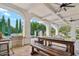 Covered patio with an outdoor kitchen featuring a stainless steel grill and wooden table for dining at 2748 E Warbler Rd, Gilbert, AZ 85297