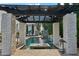 Inviting pool area with a pergola, in-water seating and waterfall features, creating a relaxing oasis at 2748 E Warbler Rd, Gilbert, AZ 85297