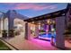 Backyard featuring a stunning pool, pergola, and elegant patio with stone accents for outdoor enjoyment at 2748 E Warbler Rd, Gilbert, AZ 85297