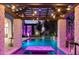 Stunning pool with a pergola, stone pillars, and elegant lighting creating a perfect backyard oasis at 2748 E Warbler Rd, Gilbert, AZ 85297